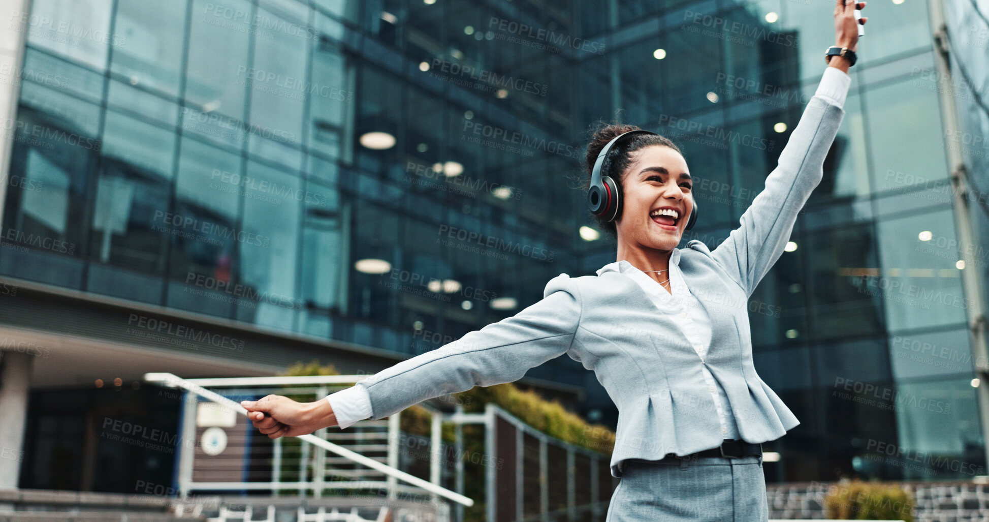 Buy stock photo Business, woman and dancing with headphones in city for music playlist, celebration and streaming audio. Excited, person and energy outdoor for sound subscription, listening to radio and work break