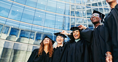 Buy stock photo Smile, students and laugh at graduation outdoor of learning success, class achievement and celebrate. Below, people and funny joke with support, academic degree and bonding together for college goals