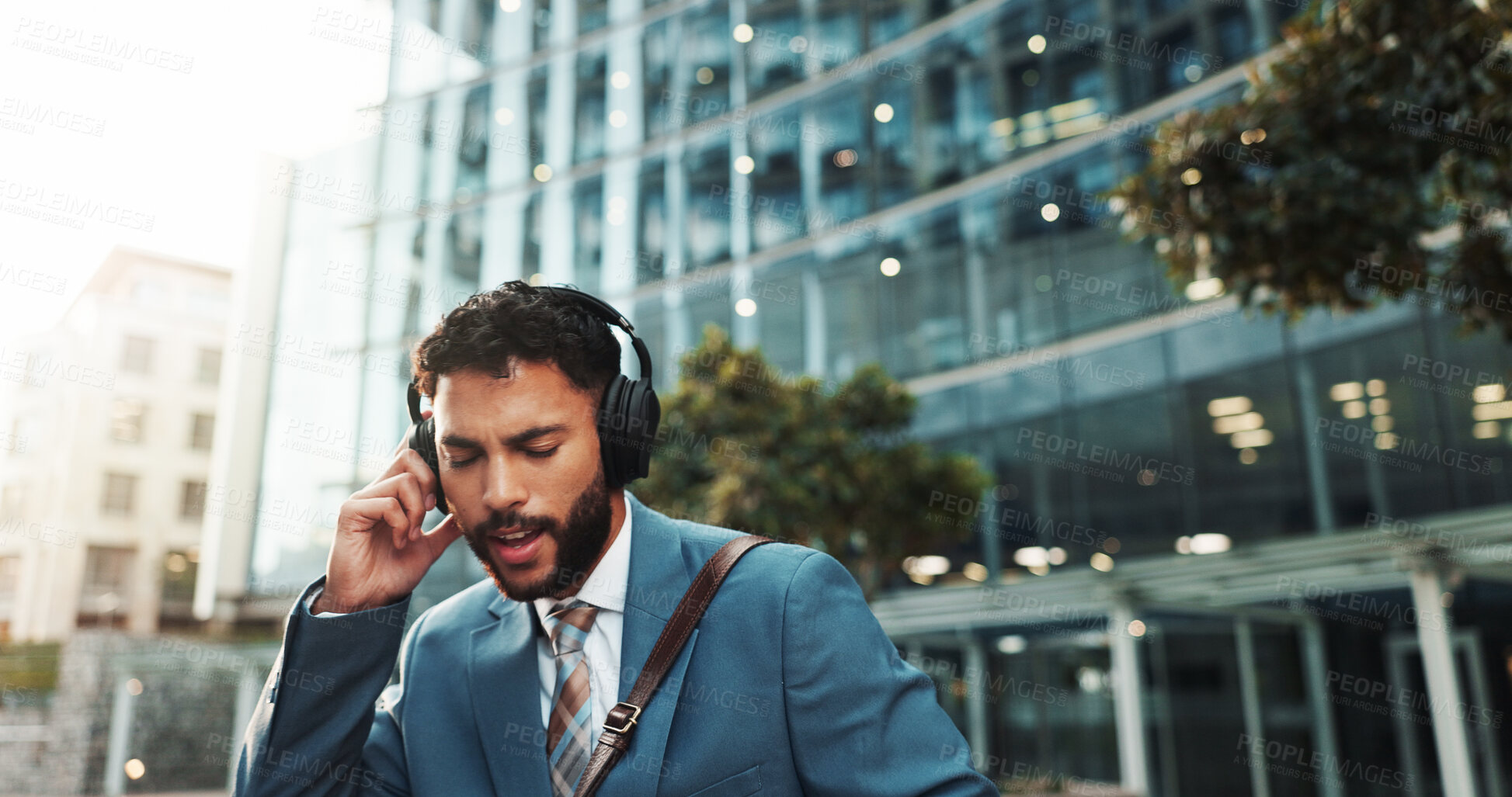 Buy stock photo Headphones, music and business man in city with playlist, singing and streaming radio for travel. Audio, outdoor and employee listening to song, urban podcast and sound on morning commute to work