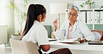 Appointment, documents or healthcare with doctor and patient in office of hospital for consulting. Clipboard, feedback or medical with mature medicine professional and woman in clinic for treatment
