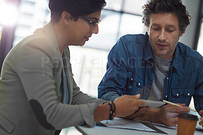 Buy stock photo Cropped shot of two business colleagues meeting in the office