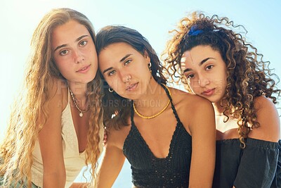 Buy stock photo Outdoor, portrait and group of friends for travel, vacation and summer holiday with hug in Spain. People, serious women or embrace by blue sky for adventure, connection or bonding together with pride