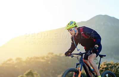 Buy stock photo Cycling, off road and sports with man in mountains for outdoor adrenaline, adventure or training. Exercise, fitness and hobby with person on bike in nature for challenge, competition or performance