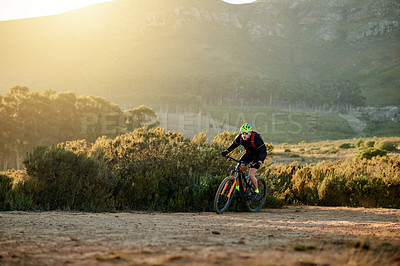 Buy stock photo Man, cyclist and nature with mountain bike for fitness, extreme sport or outdoor exercise. Active, male person or riding in wilderness with bicycle or helmet for cycling or adrenaline on dirt road