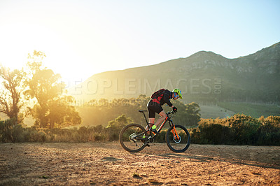 Buy stock photo Cycling, off road and speed with man in mountains for outdoor exercise, fitness or hobby. Cyclist, scenic and trail with person riding bike in nature for challenge, performance or sports training