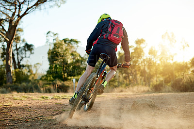 Buy stock photo Bike, dust and speed with man in mountains for outdoor adrenaline, adventure or training. Back, exercise or fitness and sports person cycling in nature for challenge, competition or performance