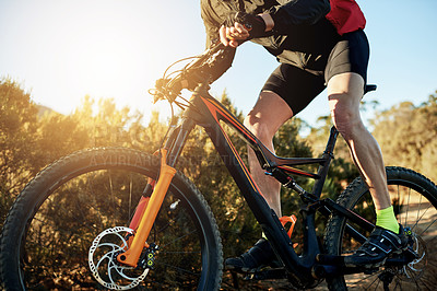 Buy stock photo Bike, gears and legs with man in mountains for outdoor exercise, fitness or hobby. Flare, frame and trail riding with person cycling in nature for challenge, performance or sports training closeup