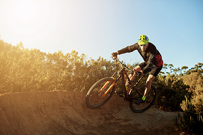 Man, cycling and mountain bike with sunset on dirt track for adrenaline rush, fitness or extreme sport in nature. Male person, cyclist or riding with bicycle for cardio workout on path, road or trail