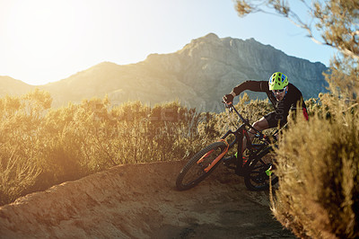 Buy stock photo Man, cycling and mountain with sunset or bicycle on dirt track for adrenaline rush, fitness or extreme sport in nature. Male person, cyclist or riding with bike for cardio on path, road or trail