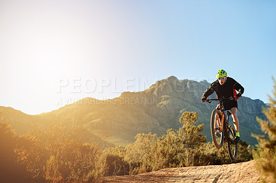 Buy stock photo Man, mountain bike and jump with sunset on dirt road for adrenaline rush, fitness or extreme sport in nature. Male person, cyclist or riding with bicycle for stunt or cardio on path, trail or space