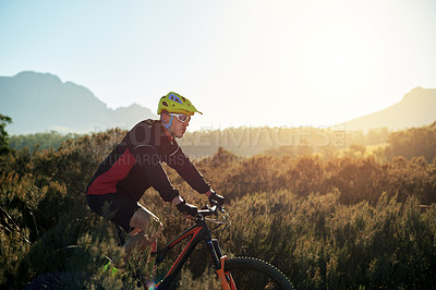 Buy stock photo Cycling, helmet and off road with man on mountain trail for outdoor exercise, fitness or hobby. Bike, flare and sunglasses with person on space in nature for challenge, performance or sports training