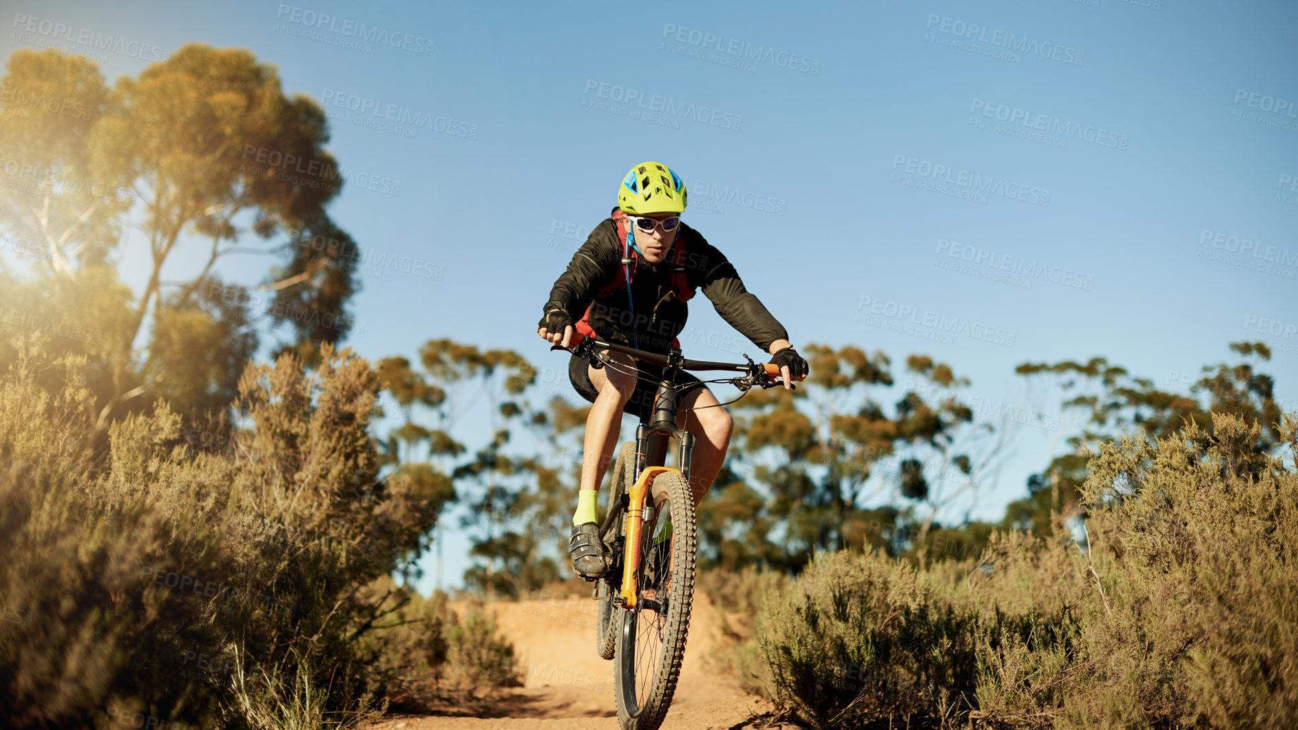 Buy stock photo Bike, off road and speed with man in mountains for outdoor adrenaline, adventure or training. Exercise, fitness and ramp with sports person cycling in nature for challenge, competition or performance