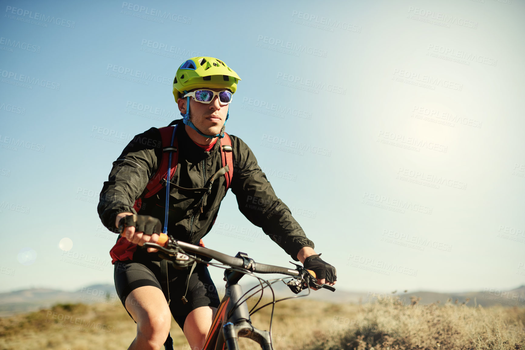 Buy stock photo Bike, helmet and off road with man in mountains for outdoor exercise, fitness or hobby. Concentration, sunglasses and trail with person cycling in nature for challenge, performance or sports training