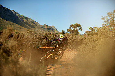 Buy stock photo Man, cyclist and mountain with bike for extreme cycling, off road or dirt track in nature. Active, male person or biker riding with helmet on desert terrain under blue sky in outdoor wilderness