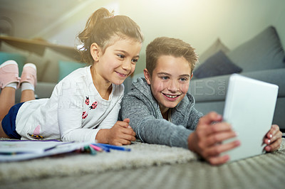 Buy stock photo Children, happy and relax in home with tablet, online game and streaming media on homework break. Kids, siblings and technology in living room for cartoon video, app subscription and weekend bonding