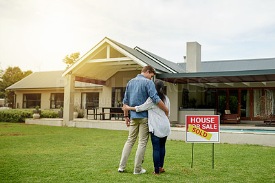 Buy stock photo Sold sign, real estate and new home for couple, hug and milestone for homeowner with property and purchase. Outdoor, embrace and people with investment of house, yard and achievement for relationship