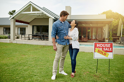 Buy stock photo Purchase, real estate and new home for couple, hug and milestone for homeowner with property and sold sign. Outdoor, embrace and people with investment of house, yard and achievement for relationship