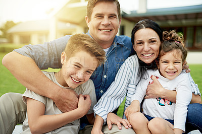 Buy stock photo Family, portrait and happy hug on grass in home backyard, love and together for security. Parents, children smile and outdoor to relax in trust embrace, support and relationship bonding in nature