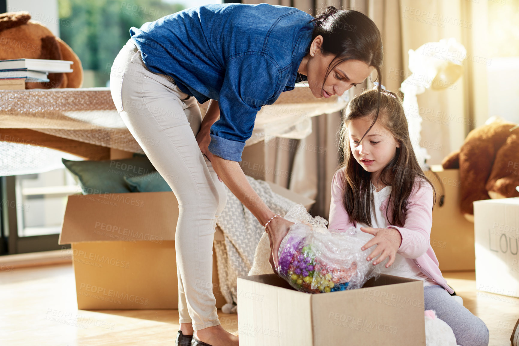 Buy stock photo Unpacking, family and mom with child, boxes and milestone with new home, moving and real estate for woman. Investment, ownership and person with daughter in living room, love and mortgage for house