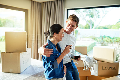 Buy stock photo Happy couple, wine and boxes in living room for move, milestone celebration and bonding on break. Property investors, people or relax in home for mortgage success, new house or excited for investment