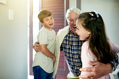 Buy stock photo Children, smile and hug grandfather for welcome in home with weekend visit, greeting and reunion. Excited people, family connection and hello by front door with bonding together and happy arrival