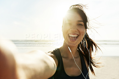 Buy stock photo Woman, selfie and exercise at beach with smile, portrait and excited for post on web with fitness at sunrise. Girl, person and happy with earphones, streaming and listen to music for workout in Italy