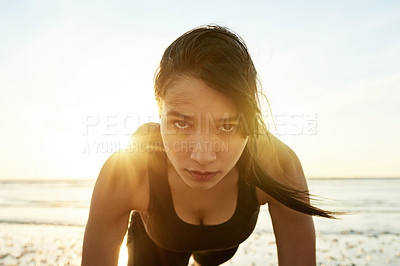 Buy stock photo Fitness, portrait and woman at ocean with push up, sunrise and commitment to healthy outdoor workout. Muscle, training and serious girl on beach for morning exercise, wellness and body care in nature