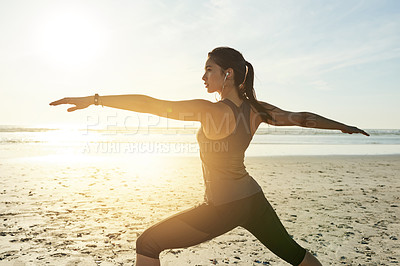 Buy stock photo Fitness, yoga and woman at sea in warrior pose for posture, wellness or holistic health in training. Exercise, nature or person stretching arms at sunset for mindfulness, body balance or awareness