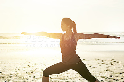 Buy stock photo Woman, music or beach yoga at sunset for balance, calm or peaceful mindset in zen nature. Warrior pose, earphones or wellness frequency tone for mental clarity, stretching or body movement by space