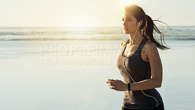 Buy stock photo Fitness, running and girl on beach with earphones, sunrise and commitment to healthy outdoor workout. Music, training and woman jogging at ocean for morning exercise, body wellness or space in nature