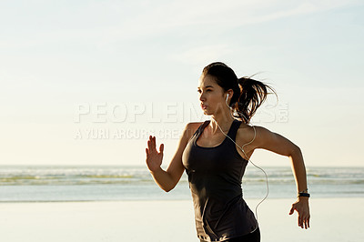 Buy stock photo Exercise, running and girl on beach with earphones, sunrise and commitment to healthy outdoor workout. Music, training and woman at ocean for morning fitness, body wellness and jogging in nature.
