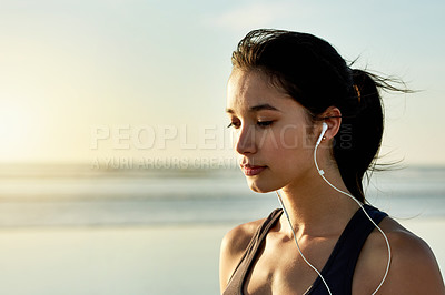 Buy stock photo Active, woman and earphones for fitness at beach from exercise, listening to music and training recovery. Female athlete, fatigue and rest with streaming audio, marathon practice and wellness workout