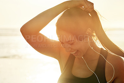 Buy stock photo Fitness, beach sunrise and smile with woman prepare for running, workout and summer with music. Athlete, happy and ready to start jog for exercise, endurance or health for wellness sport training