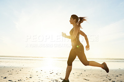 Buy stock photo Sunrise, running and girl on beach with earphones, workout and commitment to healthy outdoor exercise. Music, training and woman at ocean for morning fitness, body wellness and mockup space in nature