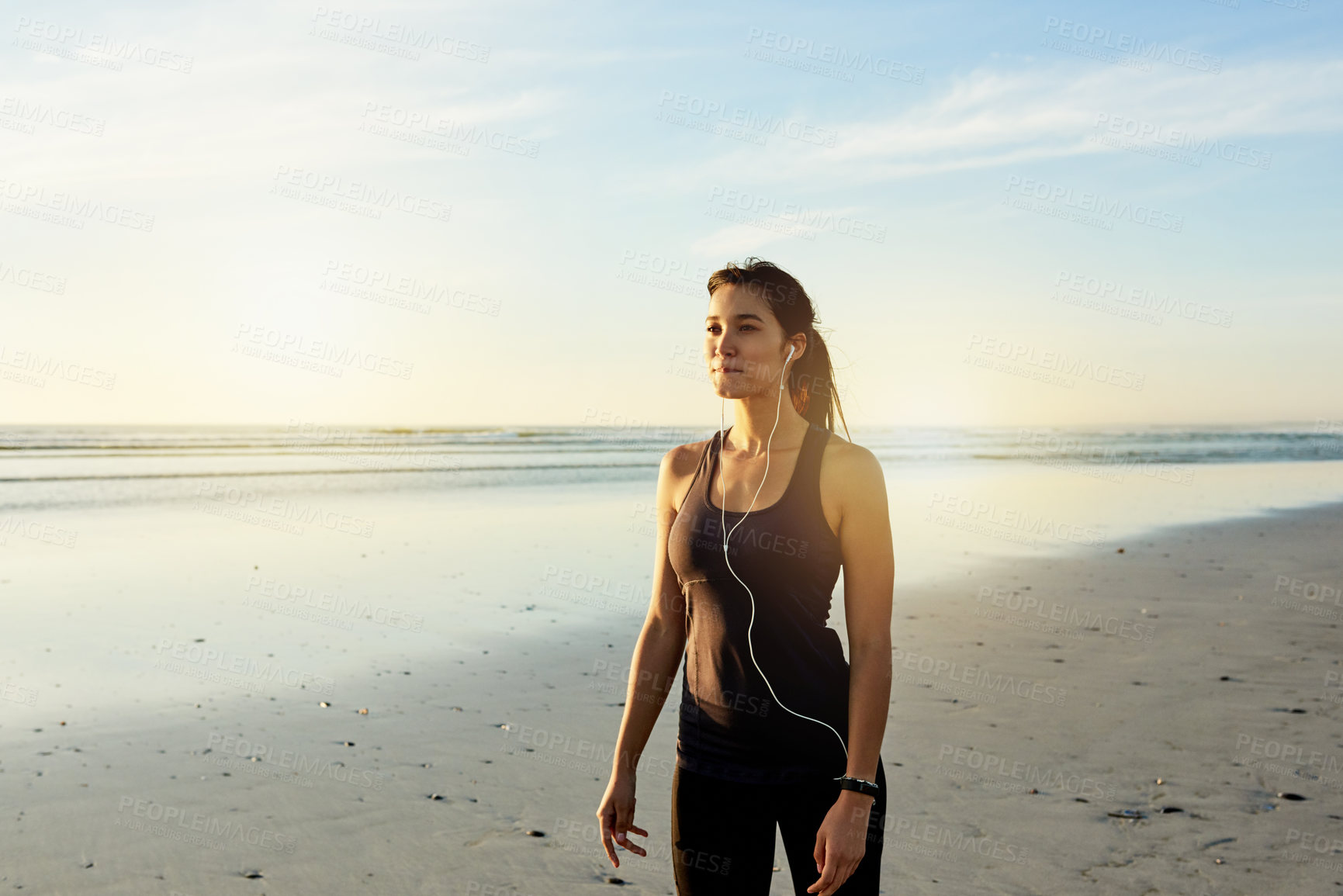 Buy stock photo Athlete, woman and earphones for fitness at beach from exercise, listening to music and training recovery. Female person, fatigue and rest with streaming audio, marathon practice and wellness workout