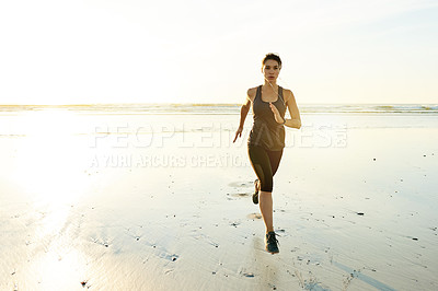 Buy stock photo Fitness, music and woman running by beach for resistance training, cardiovascular health and cardio challenge. Space, girl or sprinting with earphones for competition performance, workout or wellness