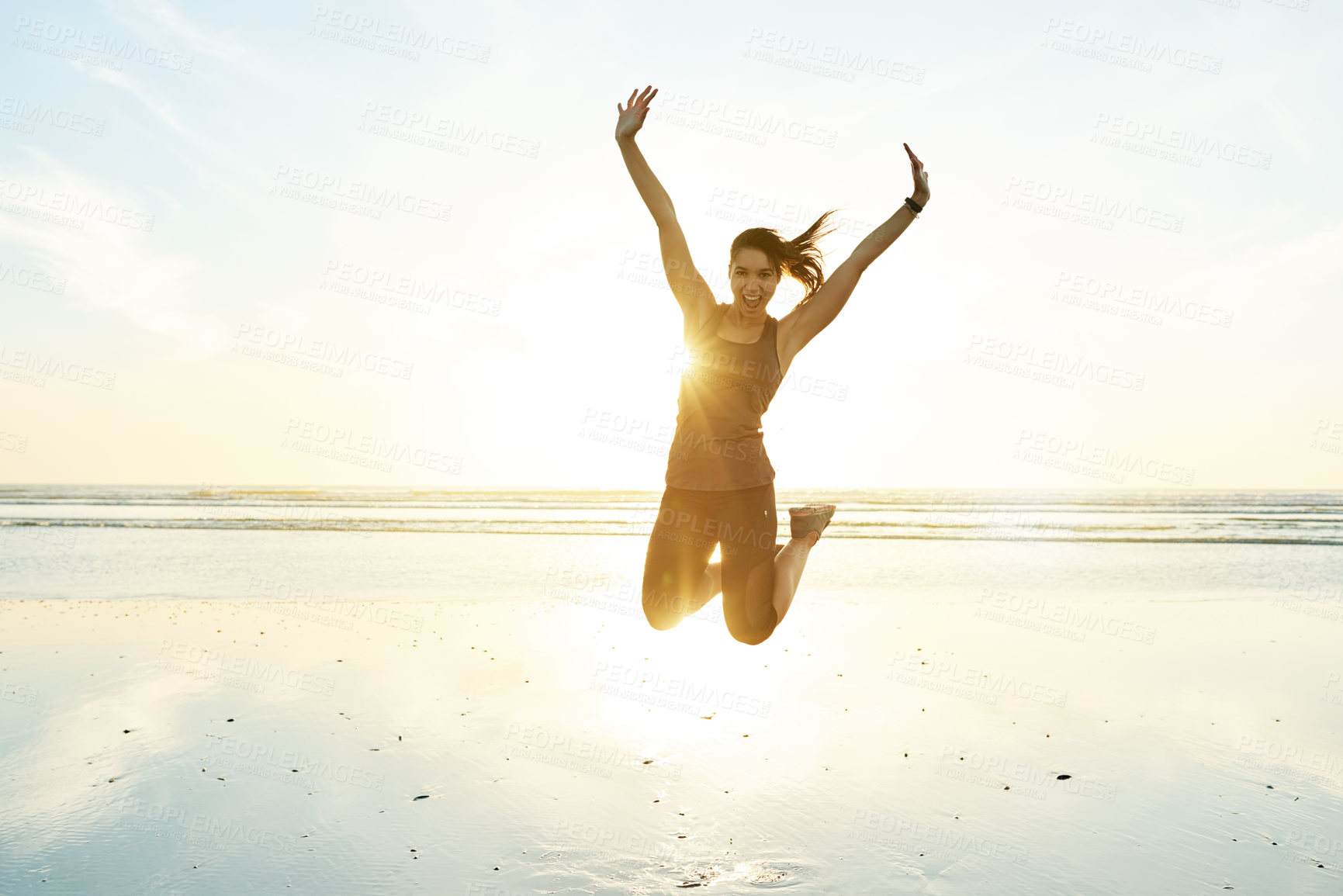 Buy stock photo Portrait, woman and jumping for fitness at beach with energy, freedom and celebration of exercise goals. Excited, female athlete or marathon winner with sports success, training achievement and ocean