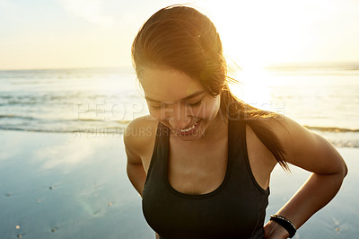 Buy stock photo Woman, happy or relax on beach for fitness, wellness or exercise break at lens flare. Runner, sunset or smile at Colombia ocean for resting, commitment or thinking of physical journey with sky space