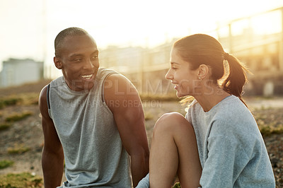 Buy stock photo Outdoor, couple and break with talking for fitness, wellness and bonding with smile for exercise. City, woman and man with support for training rest, conversation and healthy relationship by flare