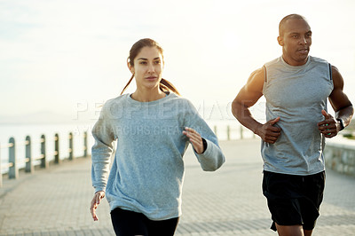 Buy stock photo Fitness, friends and running outdoor for health, body wellness or training by promenade. Team, man and woman with cardio exercise by sea for workout, sport or race with energy for endurance marathon