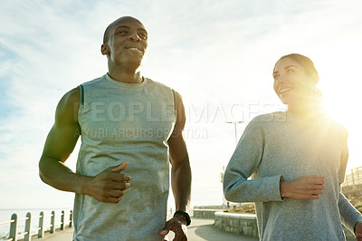 Buy stock photo Outdoor, couple and smile with running for fitness, cardiovascular health and wellness with exercise. Promenade, man and woman with training for marathon challenge, endurance and energy by flare