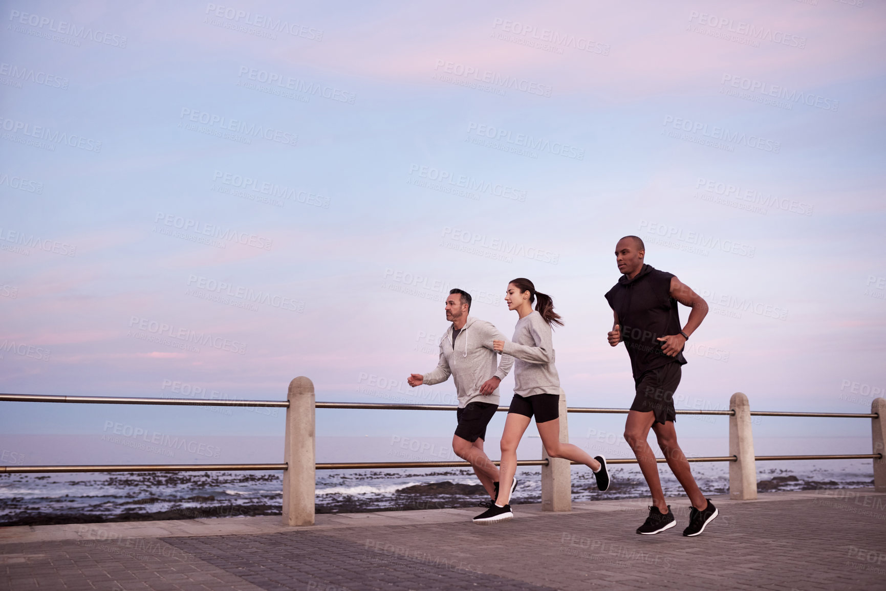 Buy stock photo Fitness group, men and woman on promenade for exercise, wellness and endurance training. Athlete, friends and running challenge with workout, physical health and resilience for cardio together
