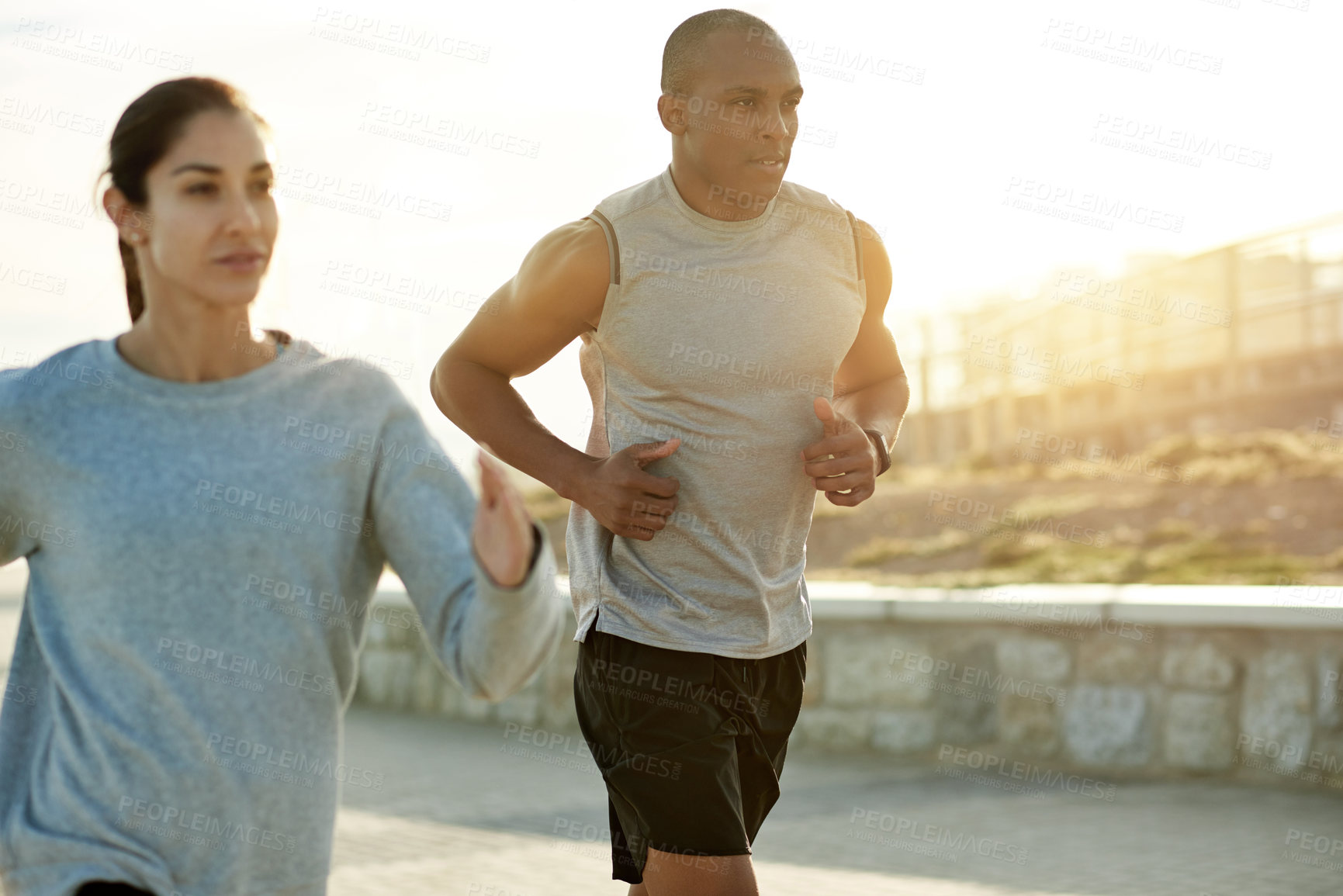 Buy stock photo Outdoor, couple and fitness with running for exercise, cardiovascular health and wellness with sports. Workout, man and woman with training for marathon challenge, endurance and energy by flare