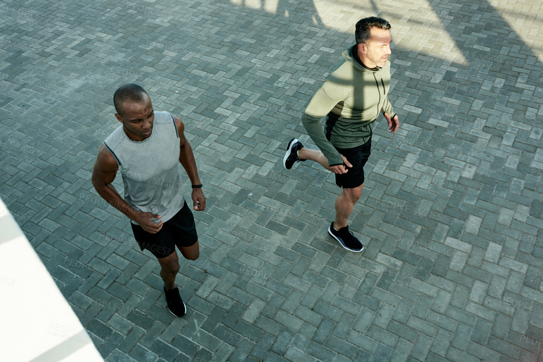 Buy stock photo Men, above or running for city fitness, exercise or workout wellness in social sports with coach. Friends, team or personal trainer for athlete marathon, race or competition training accountability