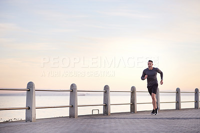 Buy stock photo Beach, running and man with fitness, morning and wellness with workout, endurance and routine. Person, athlete and runner with practice, exercise and cardio with body health, challenge and training
