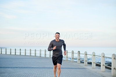 Buy stock photo Mature man, portrait and fitness on beach promenade, sports workout and activity for mobility health. Male person, physical challenge and training for marathon, outdoor and cardiovascular exercise