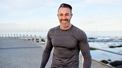 Buy stock photo Mature man, runner and happy on promenade by ocean, break or pride with portrait for workout in morning. Person, training and fitness by sea with confidence, smile or outdoor for exercise in Spain