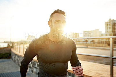 Buy stock photo Man, smile or running in city for fitness, cardio exercise or training for marathon with lens flare. Mature athlete, sunset or happy in Portugal for workout routine, physical care or wellness journey