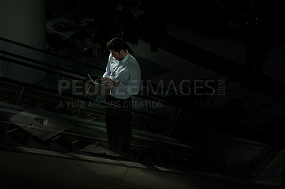 Buy stock photo Man, escalator and tablet in night office, global stock market and monitor trading economy online. Business, mockup space and electric stairs in workplace, financial site and email deadline to client