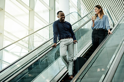 Buy stock photo Escalator, speaking and suitcase with business people in airport together for travel flight. Collaboration, happy and luggage of man employee with woman colleague in lobby for international trip